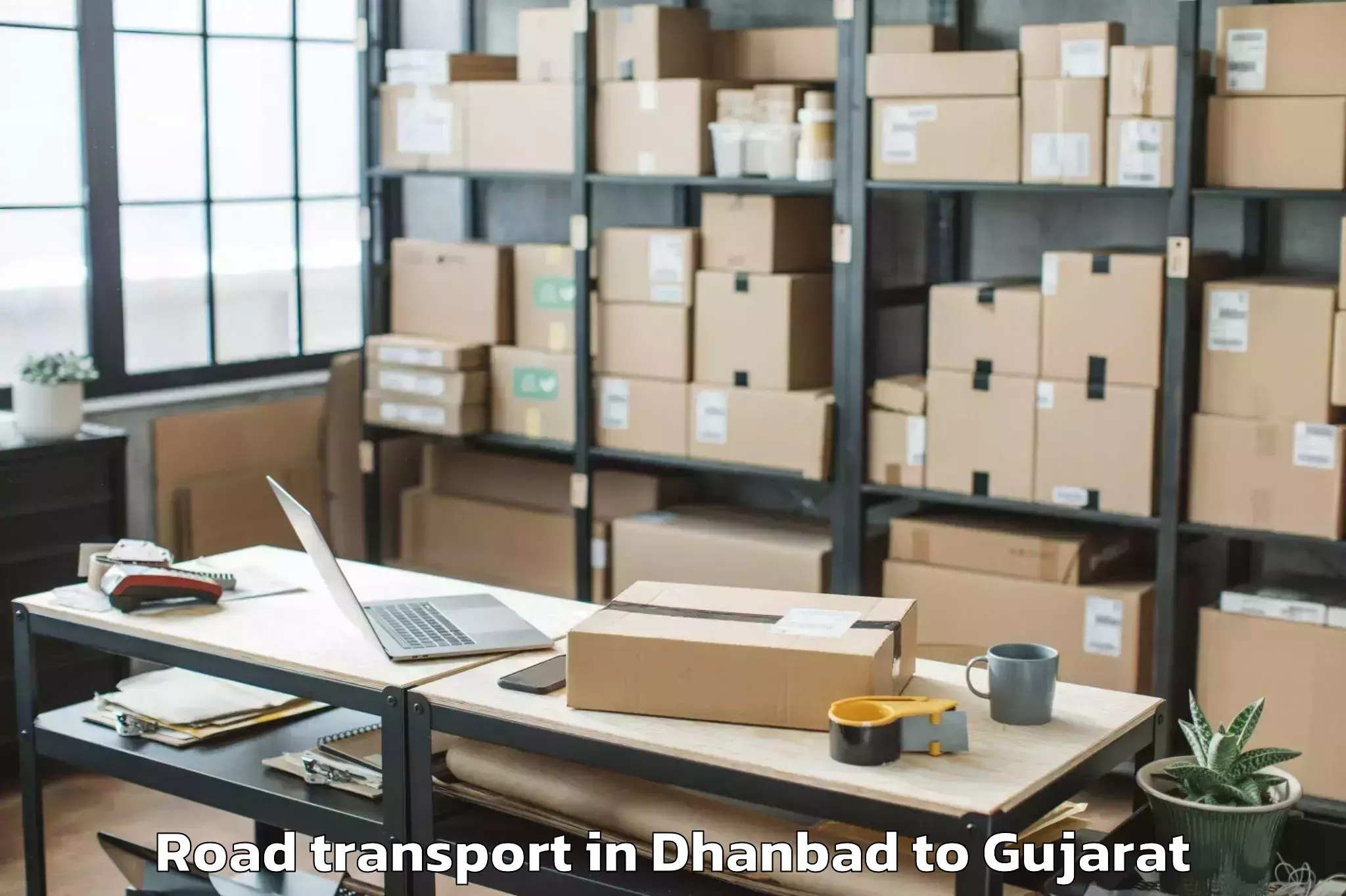 Book Dhanbad to Ganpat University Mehsana Road Transport